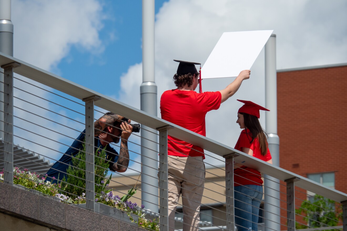 A photographer takes portraits of graduating seniors in the wake of the coronavirus pandemic, Saturday, May 16, 2020, in Cincinnati.